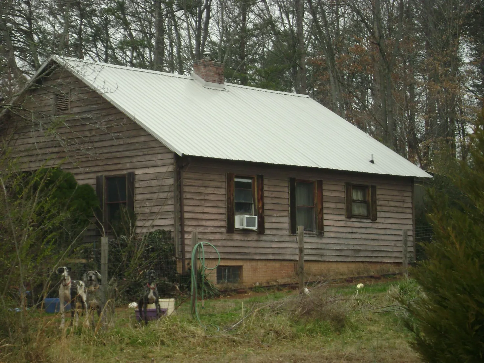 White metal roof on an old wood sided farmhouse, from a Asphalt Shingle Roof Repair job in Walton